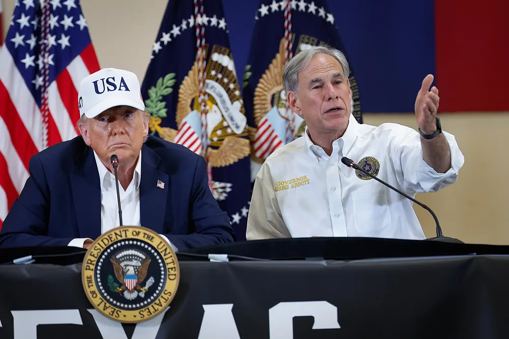 President Donald Trump and Texas Governor Greg Abbott participate in a round table event to discuss a flash flood that hit Texas in July.